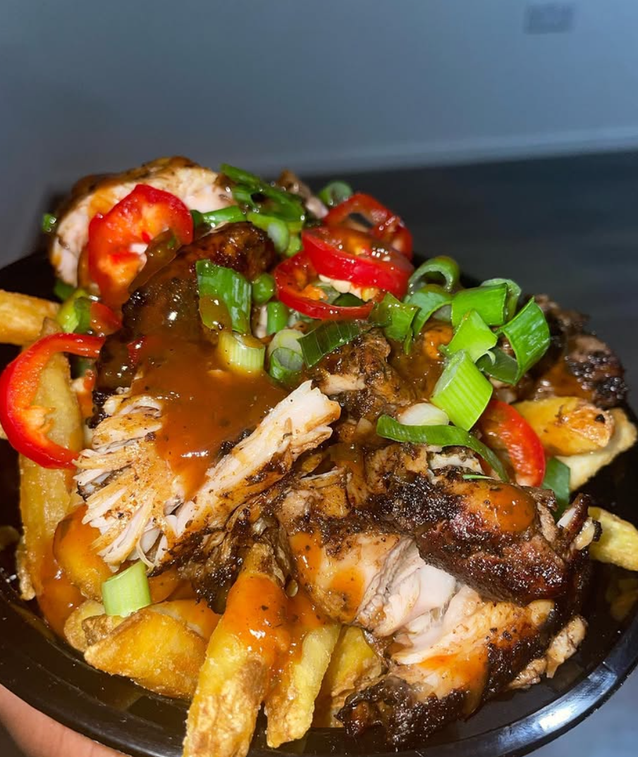 Kinna's Kitchen UK jerk chicken loaded fries with house sauce, spring onion and red chilli